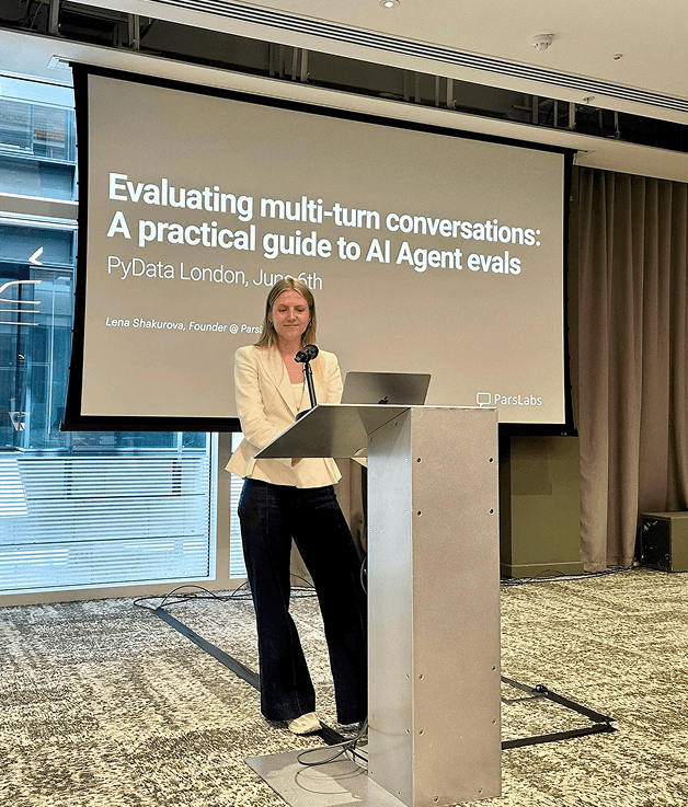 Lena at the podium presenting a practical guide to AI agent evals