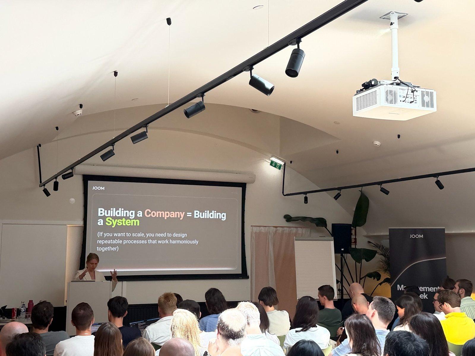 Lena presenting to a full room of managers during the 3-day AI training intensive