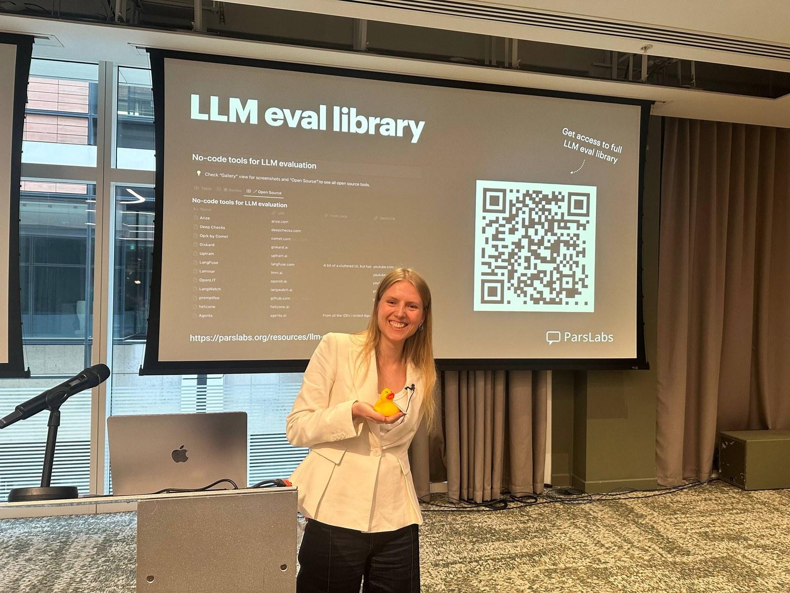 Lena on stage at PyData London 2026, presenting the LLM eval library