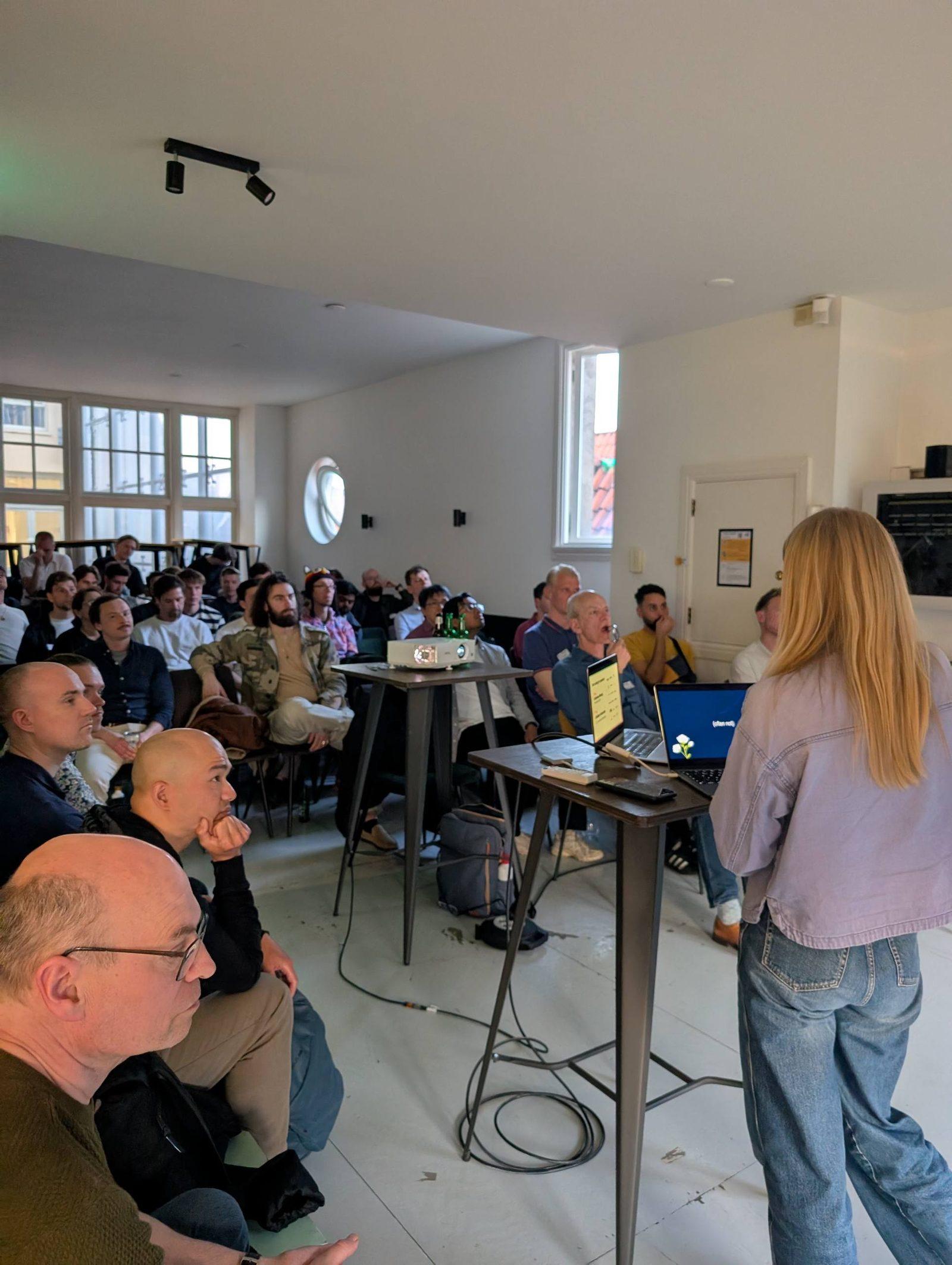 Lena speaking to a full room at the AI Builders meetup