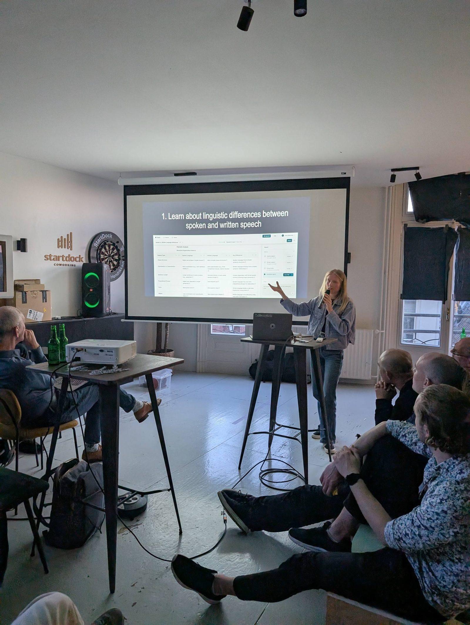 Lena presenting on stage at the AI Builders meetup